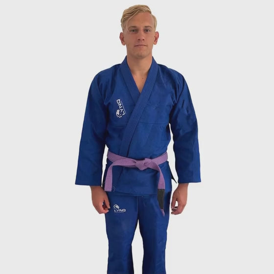 athelete walking in a blue brazillian jiu-jitsu gi